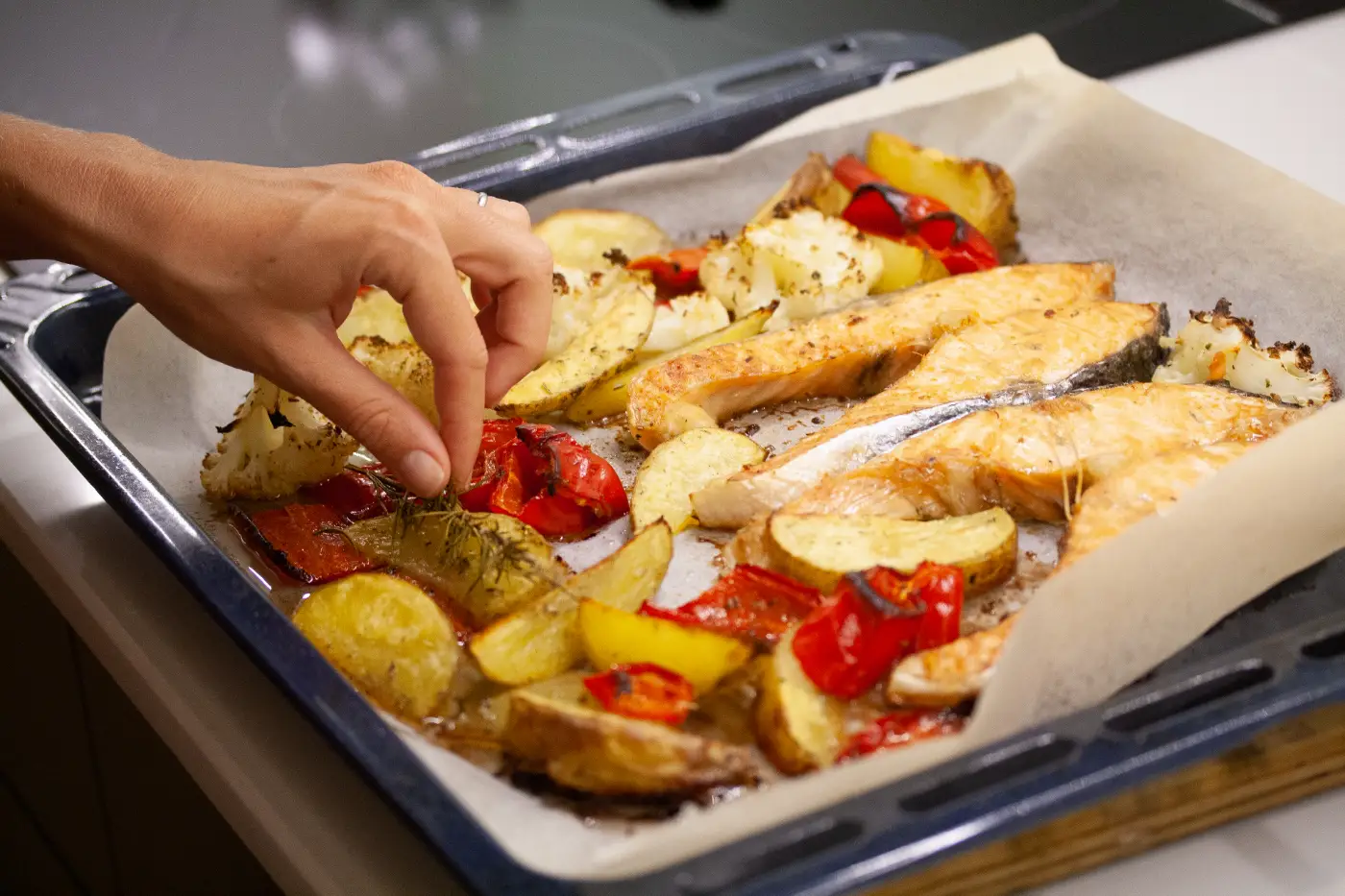 girl-preparing-fish-with-vegetables-2022-11-02-16-21-00-utc